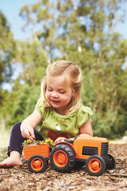 Pomarańczowy traktor z przyczepą od Green Toys