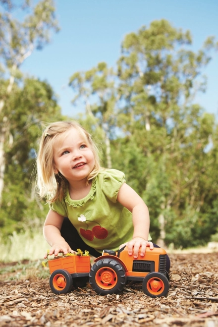 Pomarańczowy traktor z przyczepą od Green Toys